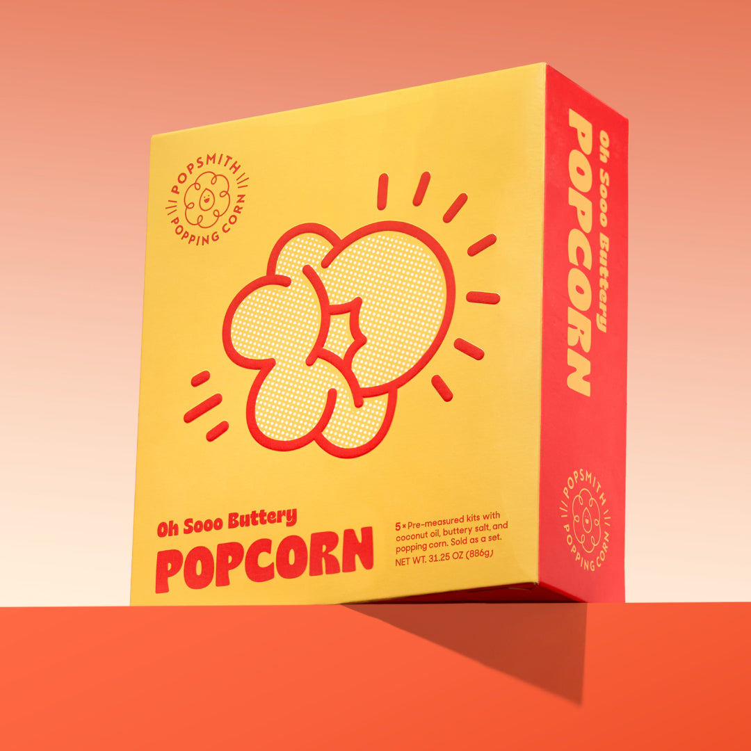 A box of Oh Sooo Buttery popcorn on a red gradient background
